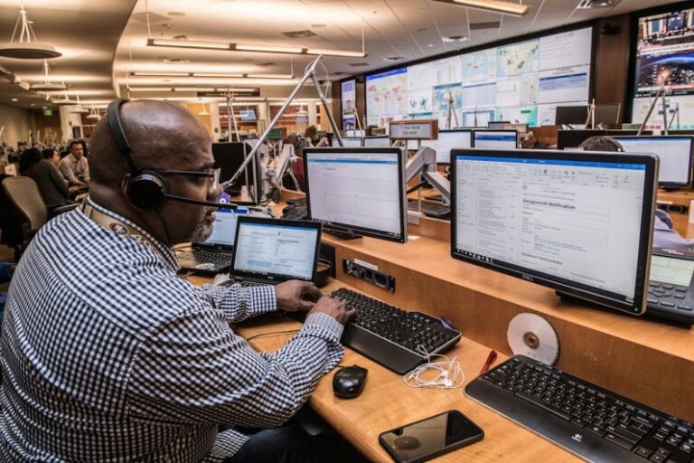 Fleet Management - man in black and white checkered dress shirt using computer