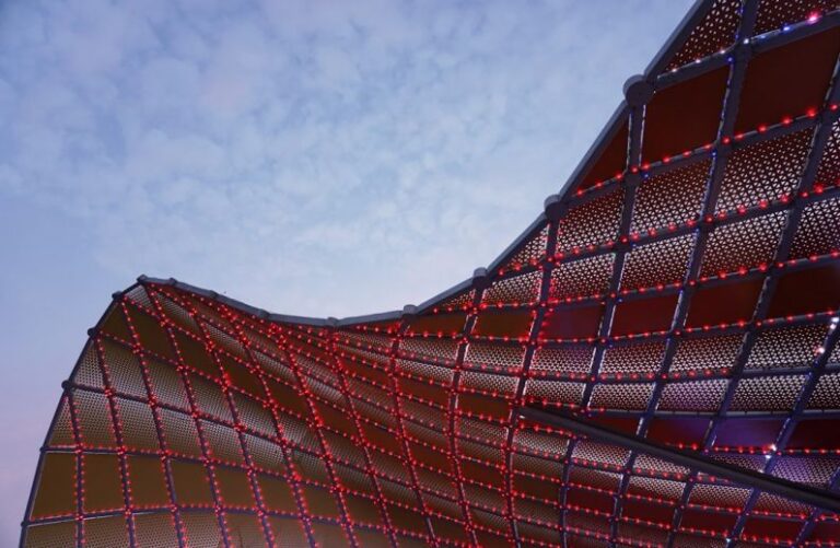 Seamless Experience - a close up of a building with red lights on it