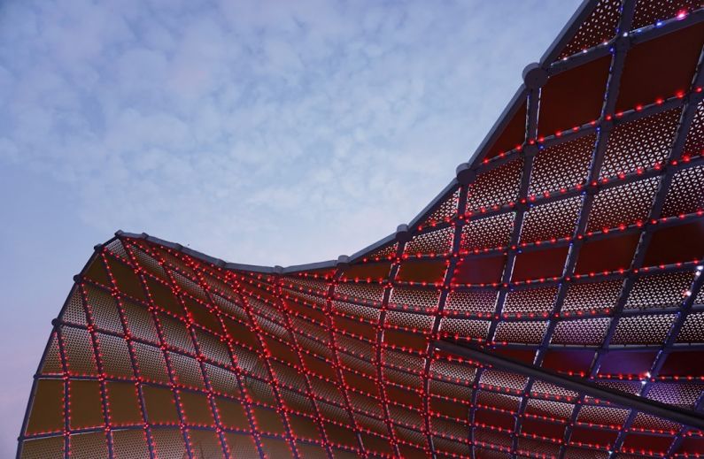 Seamless Experience - a close up of a building with red lights on it