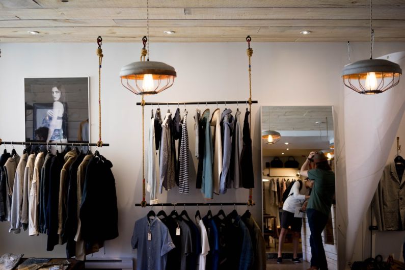 Inventory E-commerce - person leaning on wall while holding gray hat