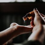 Packaging Balance - person holding amber glass bottle