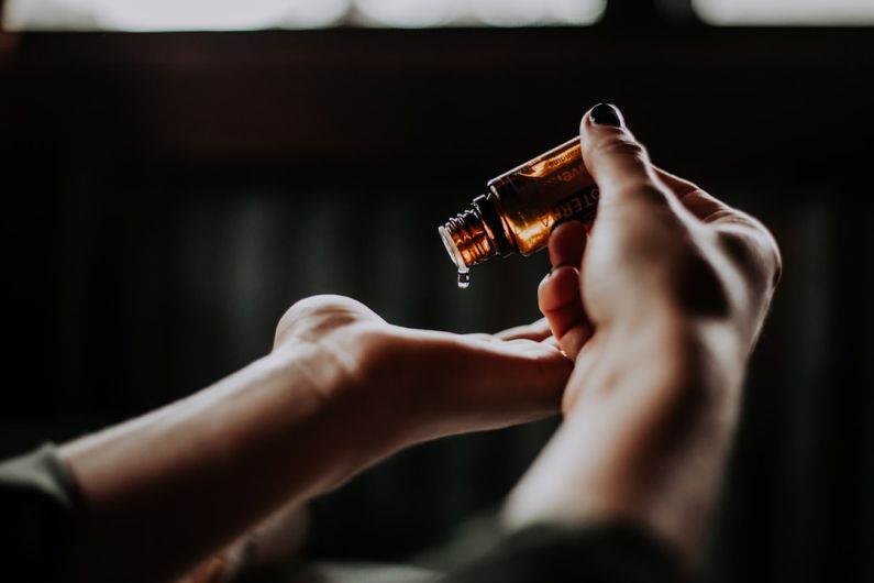 Packaging Balance - person holding amber glass bottle