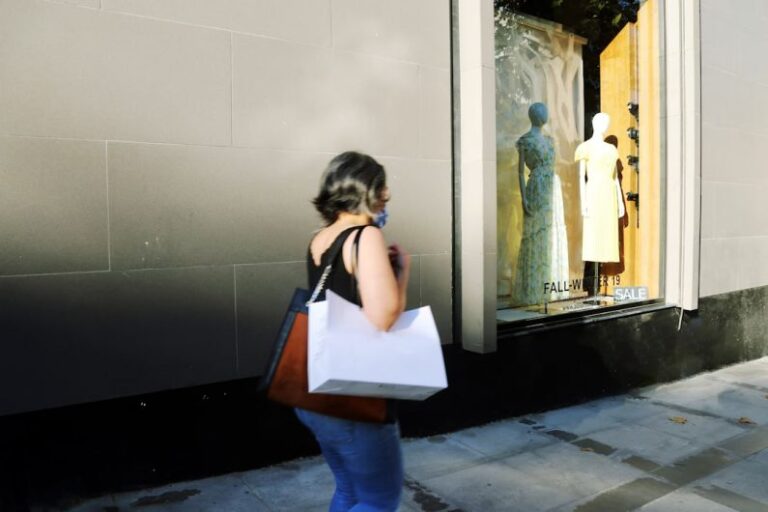 Behavior E-commerce - woman in white shirt and blue denim jeans standing in front of mirror