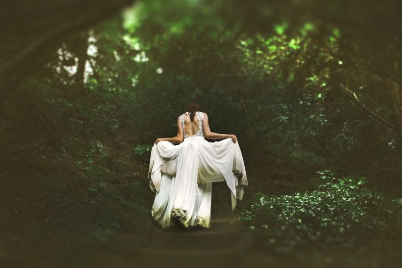 Career Shift - woman in white dress walking on pathway surrounded by trees