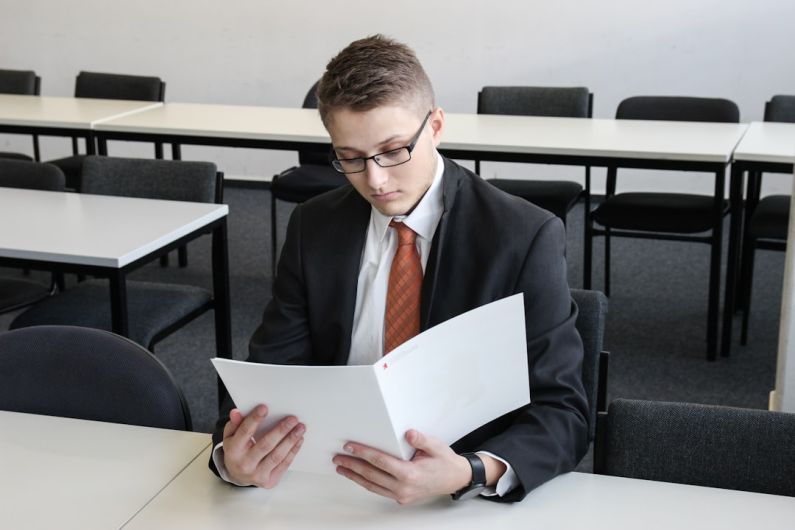 Resume Tips - man holding folder in empty room