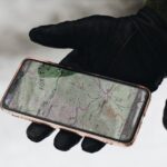 GPS Tracking - person holding iphone 6 with case