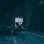 Electric Truck - trailer truck passing on road near rail guard