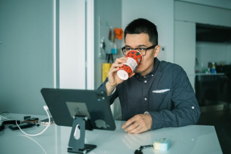 Visibility Monitor - man in black and white checkered dress shirt drinking from brown and white ceramic mug