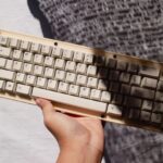 Custom Products - a hand holding a keyboard