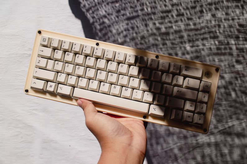 Custom Products - a hand holding a keyboard