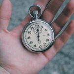 Just-in-time - person holding white and silver-colored pocket watch