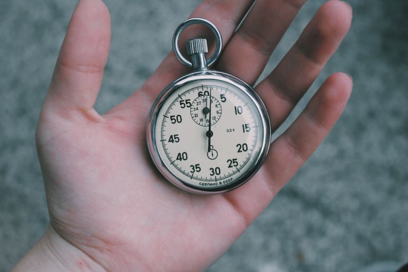 Just-in-time - person holding white and silver-colored pocket watch