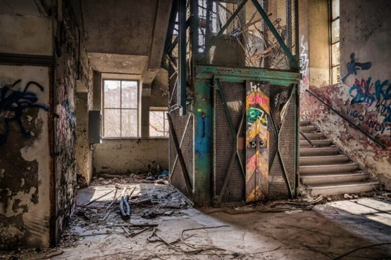 Stopwatch Factory - black metal gate near concrete wall