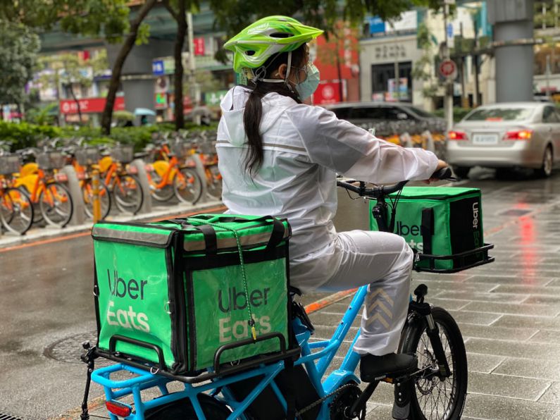 Last-mile Delivery - a person riding a bike with a cooler strapped to the back