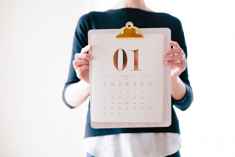 Calendar Rush - person holding calendar at January