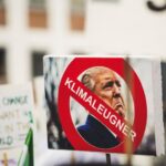 Political Instability - Donald Trump photo with klimaleugner sign