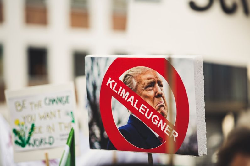 Political Instability - Donald Trump photo with klimaleugner sign