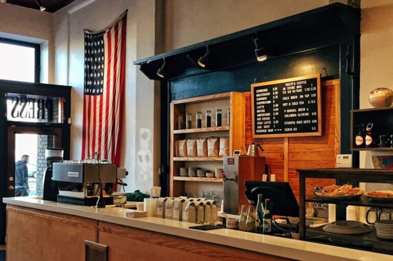 Local Partner - flag of U.S. America hanging on white painted concrete wall