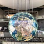Emerging Globe - giant globe inside building