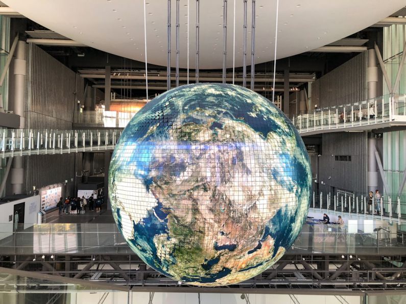 Emerging Globe - giant globe inside building