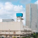 Warehouse Design - a tall building with a blue sign on top of it