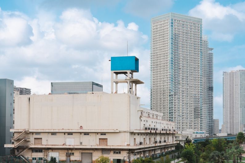 Warehouse Design - a tall building with a blue sign on top of it